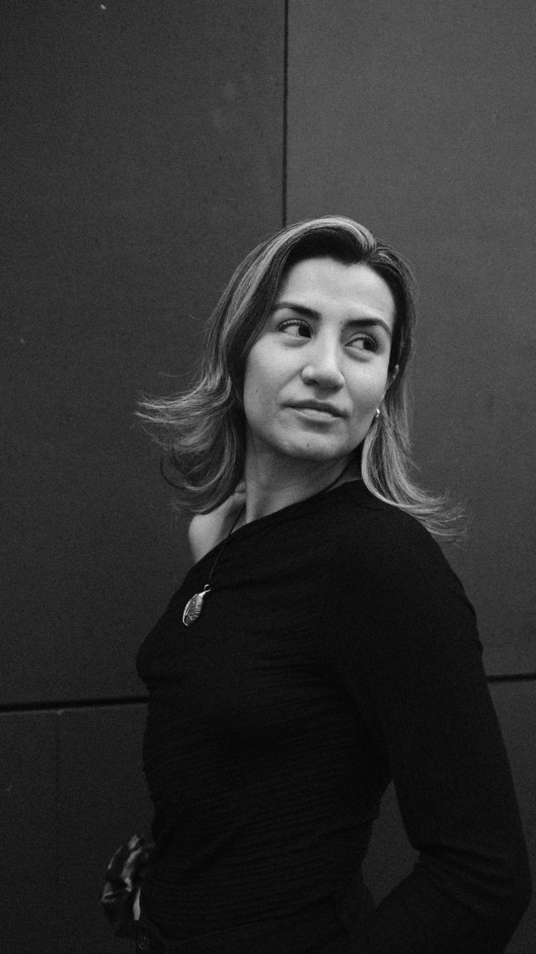 Black and white portrait of a woman looking over her shoulder