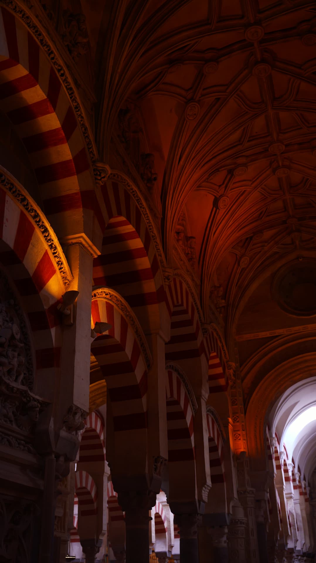 Striped arches and carved ceiling of the Mezquita cathedral in Córdoba
