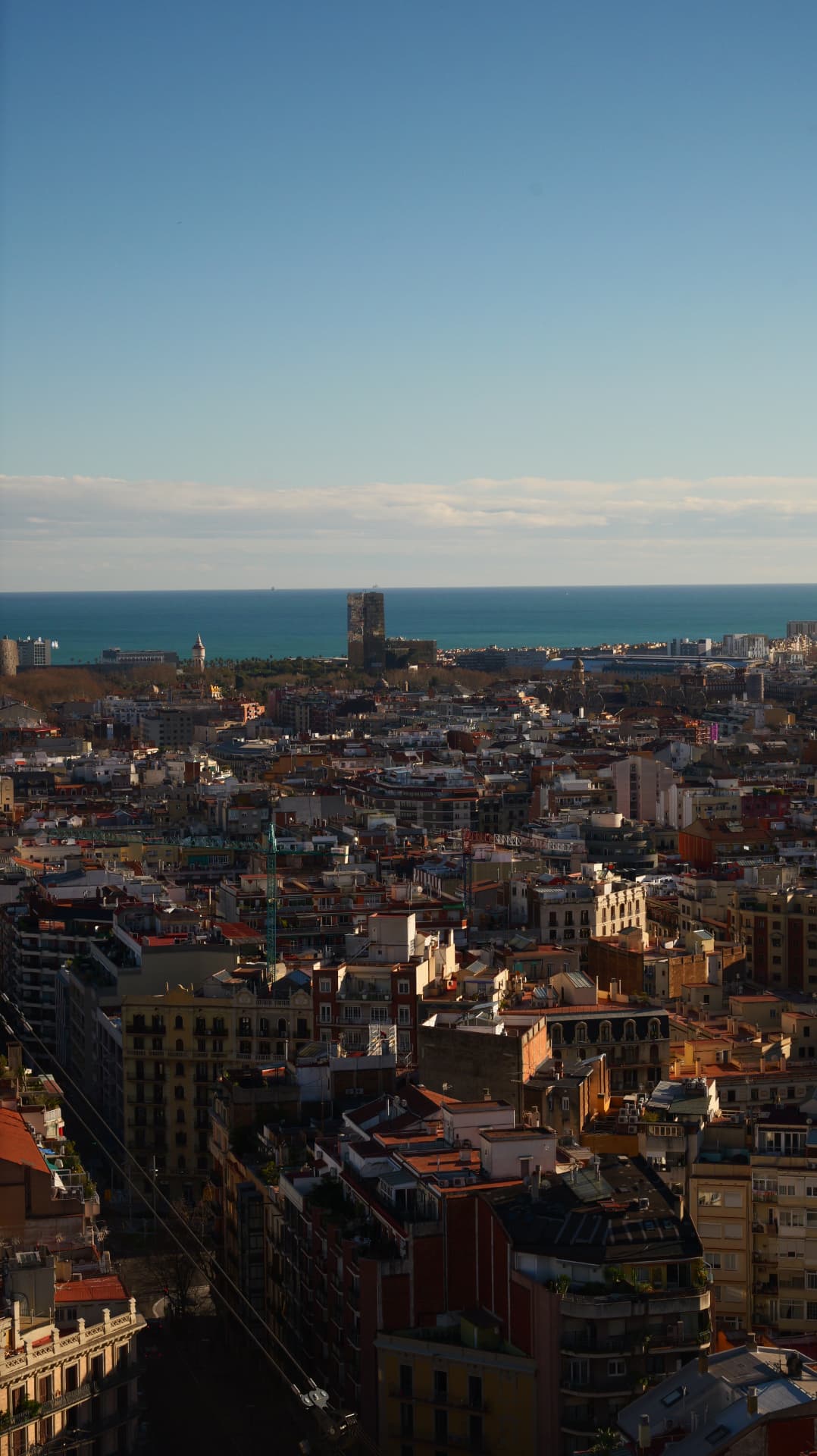 Barcelona rooftops stretching to the sea seen from above