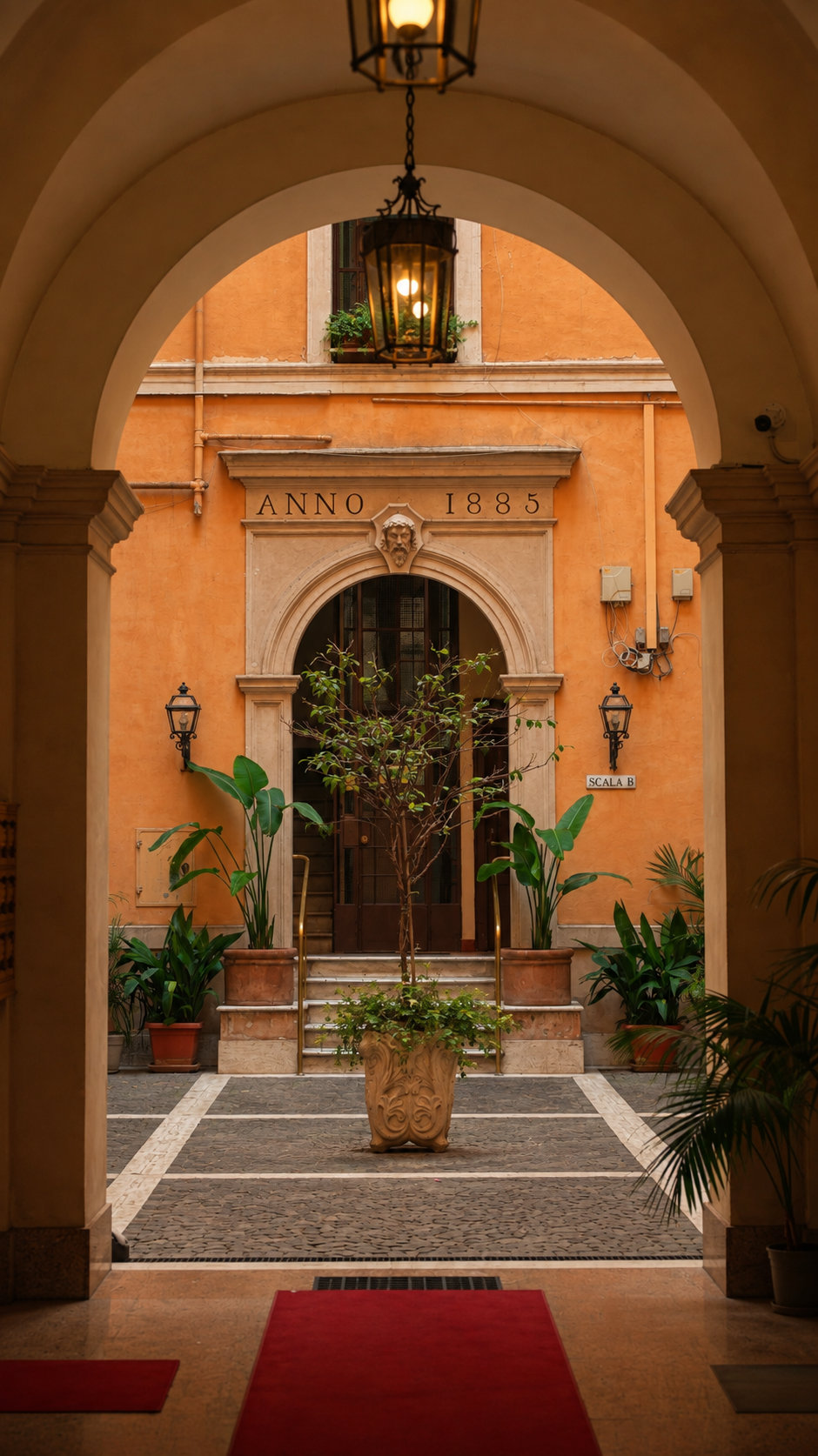 Lantern-lit Roman courtyard with an Anno 1885 doorway and potted plants