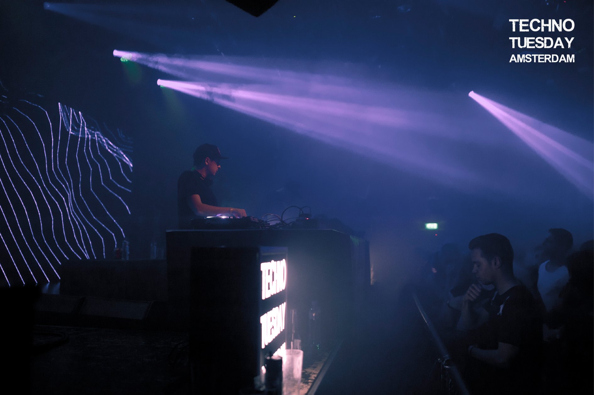 Techno Tuesday Amsterdam — DJ under violet beams