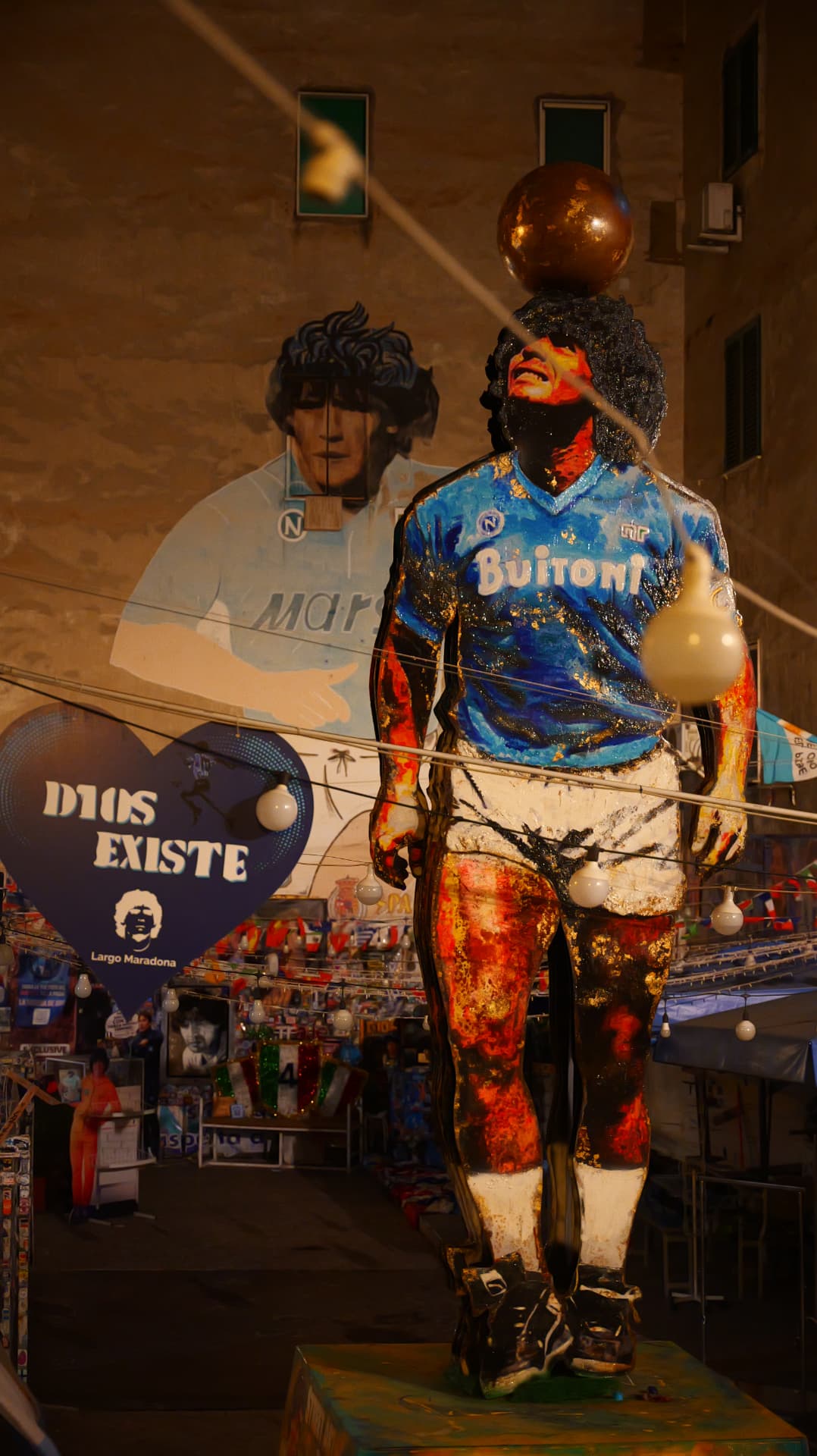 Painted Maradona statue and mural at Largo Maradona in Naples