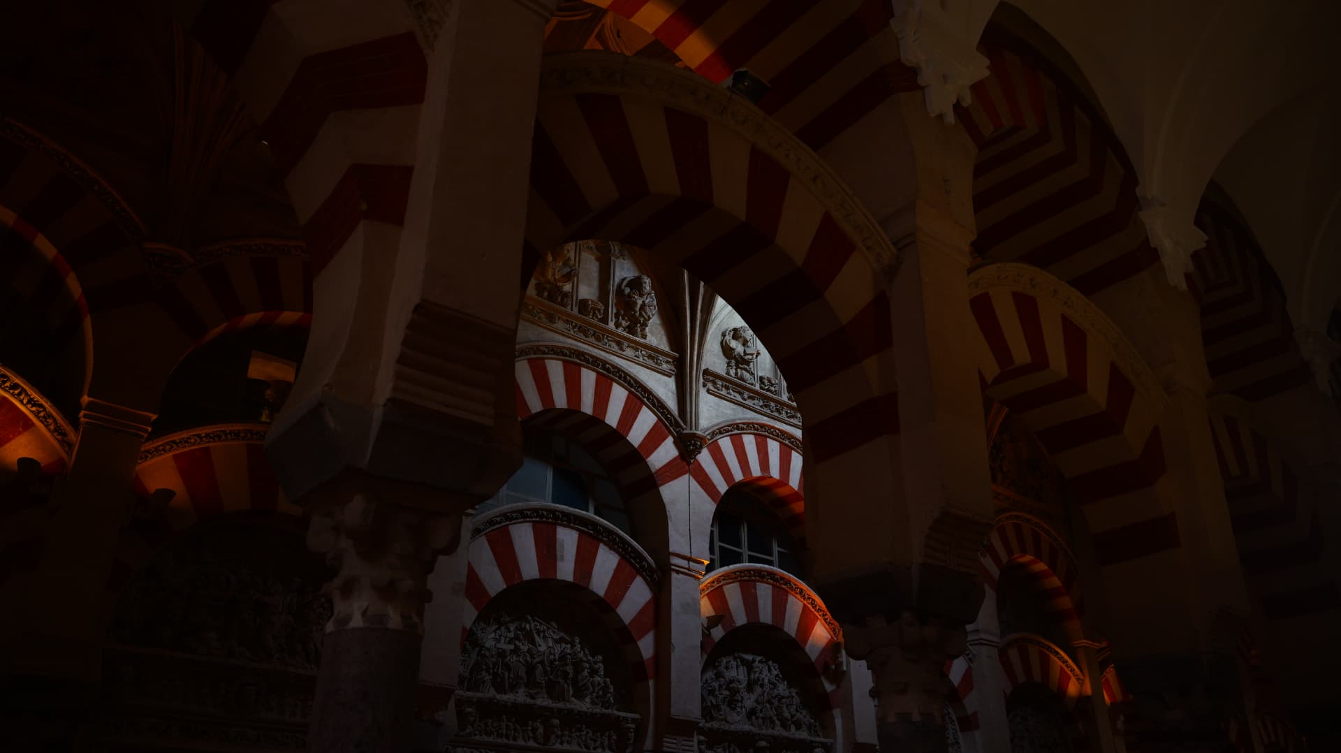 Red-and-white striped arches of the Mezquita in Córdoba at night