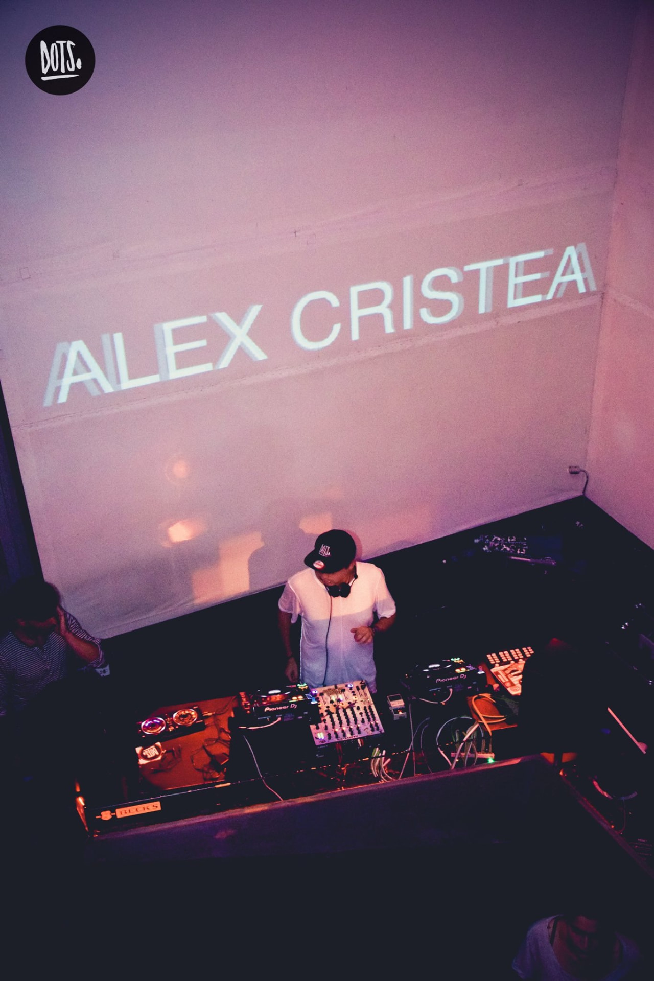 Alex Cristea projected on the wall above the DJ booth at a DOTS. night